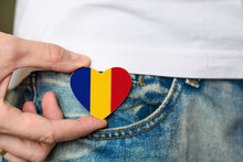 Patriot Of The Romania! Wooden Badge With Romania Flag In The Shape Of A Heart In A Man's Hand On National Unity Day.
