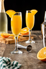 Orange mimosa cocktail on wooden table