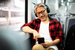 © Jelena - Senior man traveling by train. Man listening the music while enjoying in travel...