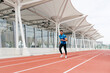 © ADDICTIVE STOCK - Athletic man running on the running track