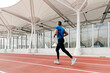 © ADDICTIVE STOCK - Athletic man running on the running track