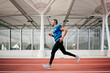 © ADDICTIVE STOCK - Athletic man running on the running track