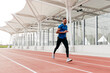 © ADDICTIVE STOCK - Athletic man running on the running track