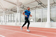 © ADDICTIVE STOCK - Athletic man running on the running track