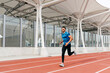 © ADDICTIVE STOCK - Athletic man running on the running track