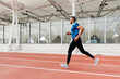 © ADDICTIVE STOCK - Fit man with sportswear and sunglasses running on the field track