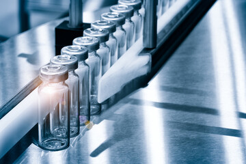 Glass bottles in production in the tray of an automatic liquid dispenser, a line for filling medicines against bacteria and viruses, antibiotics and vaccines.