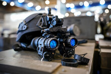 Night Vision Goggles On Military Helmet, Closeup Detail To Blue Reflective Lenses