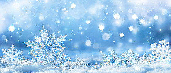 snowflakes on snow - christmas and winter background - natural snowdrift close up with abstract ligh