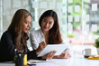 © Prathankarnpap - Business people using digital tablet and discussing about project startup ideas at modern office.