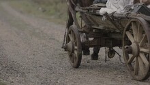 Ancient Wooden Horse Cart Moving By Rural Country Road Historical Site. History Film Shot. 4K Slow Motion.
