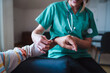 © Lomb - Smartwatch for health care. A woman from the medical health system wears a smartwatch for remote monitoring of vital signs on an elderly person - assisted living concept