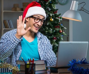 Wall Mural - Young man working at home on christmas day