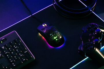 Poster - Gaming composition with mouse, keyboard, jopad and headset on gaming led mat