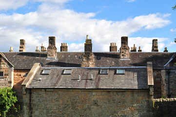 Wall Mural - Roofs & Chimneys on Old 19th Century Buildings against Blue Sky