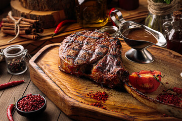 Wall Mural - Top view on grilled beef tomahawk steak with pepper sauce