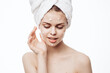 © VICHIZH - cheerful woman with a white towel on her head face cream skin care
