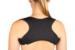 Posture corrector. Woman wearing back support belt for support and improve back posture isolated on white background. Scoliosis treatment. Orthopedic posture corrector. Back view