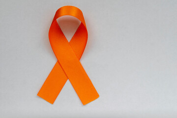 Wall Mural - orange ribbon, symbol of the fight against skin cancer, melanoma, orange December