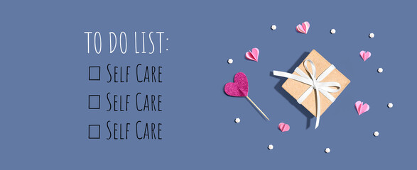 self care - to do list with a small gift box and paper hearts