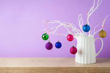 Wall Mural - Christmas holiday creative decoration on wooden shelf over violet background