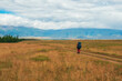 © sablinstanislav - Solo hiking in the picturesque autumn mountain valley. Heavy climb in the mountains with a big backpack. Travel lifestyle, hiking hard track, adventure concept in autumn vacation.