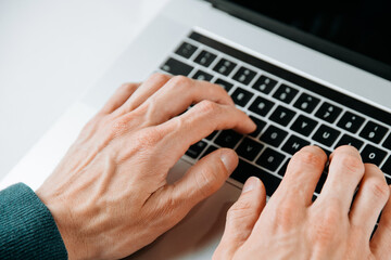 Wall Mural - close up. casual male typing on a laptop keyboard.