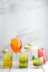 set of six cocktail on light background. many fresh cocktails or lemonade. Different delicious cocktails on light tile table in bar