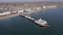 Aerial Footage Towards Eastbourne Pier And The Elegant Seafront At This Popular Resort Town In East Sussex.