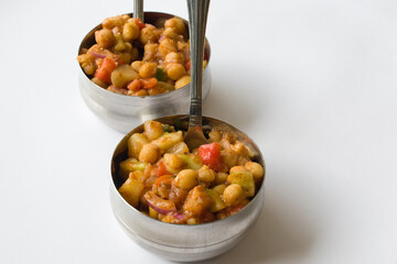 Wall Mural - Delicious Indian chaat (salad) made of chickpeas, fruits, tomatoes, onion and different masalas in steel bowl ready to eat