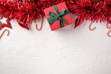Poster - Christmas start and tinsel,gift box decoration ornament on white concrete table background