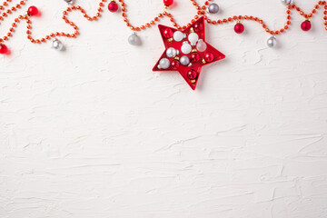 Poster - Christmas ball and tinsel and star decoration ornament on white concrete table background