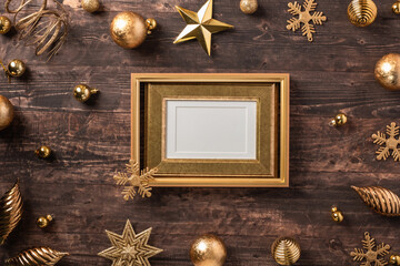 Poster - Christmas gold picture frame and bauble,star decoration ornament on brown wood table