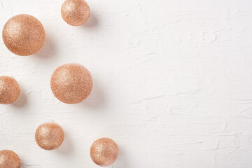 Poster - Christmas gold bauble ball decoration on white pastel table background