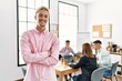 © Krakenimages.com - Young hispanic businessman smiling happy standing with arms crossed gesture at the office during business meeting.