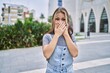 © Krakenimages.com - Young caucasian woman outdoors shocked covering mouth with hands for mistake. secret concept.