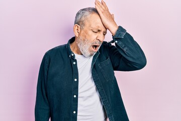 Poster - Handsome senior man with beard wearing casual denim shirt surprised with hand on head for mistake, remember error. forgot, bad memory concept.