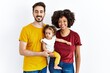 © Krakenimages.com - Interracial young family of black mother and hispanic father with daughter with a happy and cool smile on face. lucky person.