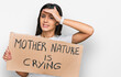 © Krakenimages.com - Young hispanic girl holding mother nature is crying protest cardboard banner stressed and frustrated with hand on head, surprised and angry face