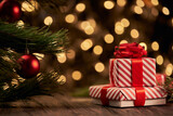 Fototapeta Panele - Christmas gift box and trinkets on a background of unfocused golden lights.