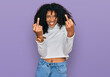 Young african american girl wearing casual clothes showing middle finger doing fuck you bad expression, provocation and rude attitude. screaming excited