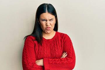 Poster - Beautiful brunette woman wearing wool winter sweater skeptic and nervous, disapproving expression on face with crossed arms. negative person.