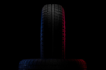 tires with a tread for driving in winter close-up on a black background