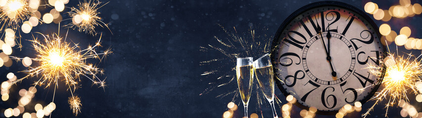 HAPPY NEW YEAR 2022 - Festive silvester New Year's Eve Party celebration background panorama banner long - Golden yellow fireworks, sparklers, clock and champagne classes toasting in the blue night