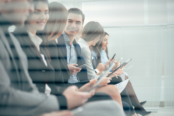 Wall Mural - group of young candidates with questionnaires sitting in the office corridor