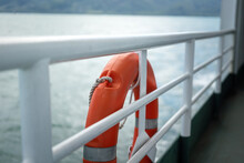 A Rescue Lifebuoy Which Is Installed On Ship Corridor Rail, Stand By For People Overboard Into The Sea. Emergency Equipment For Transportation Object Photo. Selective Focus.