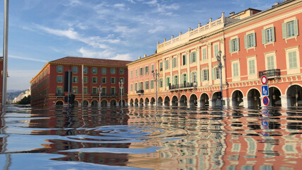 Flooded city with old buildings under water. Climate change and environmental disaster concept. Digital manipulated image. Blue sky background.
