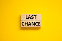 Time To Last Chance Symbol. Concept Words Last Chance On Wooden Blocks On A Beautiful Yellow Background. Business And Time To Last Chance Concept. Copy Space.