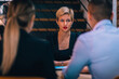 © qunica.com - An attractive blonde with red lipstick explaining her strategy on a business meeting in a restaurant