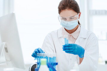 Wall Mural - close up .female scientist looking at test tube .